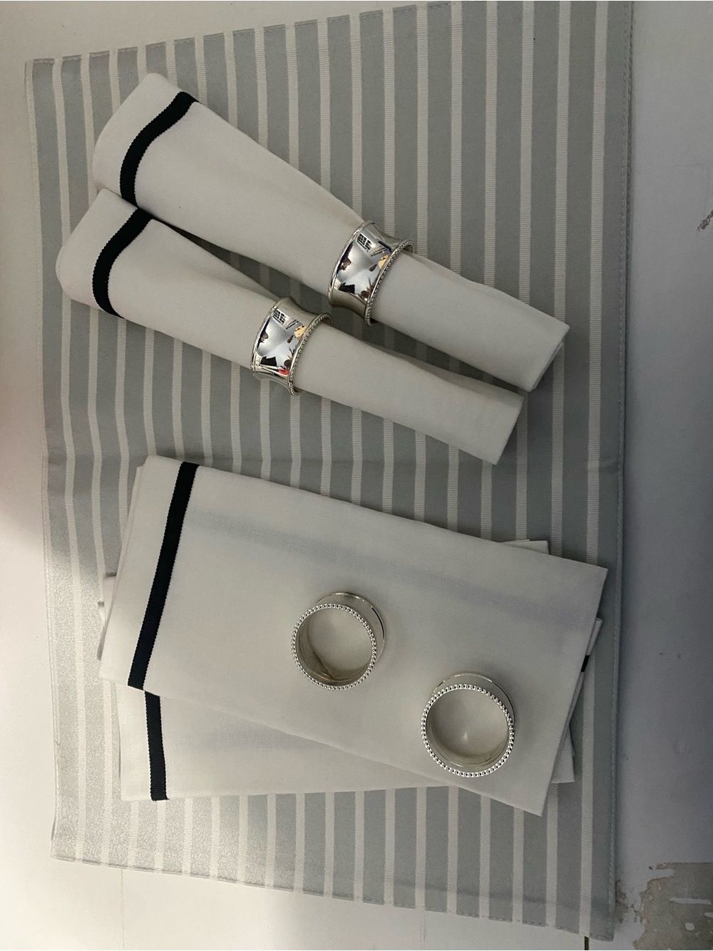 White and Black Trim napkins plus grey and white strip place mats.  Kate Spade.
